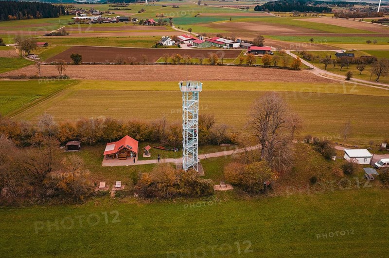 View of an observation tower in a rural area with fields and a village in the background, Dürrenmettstetten observation tower, Germany