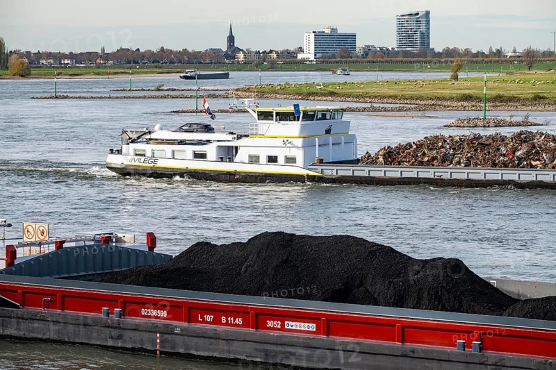 Dutch cargo ship Orfeo, brings power plant coal from the Netherlands to Mannheim, here on the Rhine near Düsseldorf, behind freighter with scrap metal, sails downhill, North Rhine-Westphalia, Germany