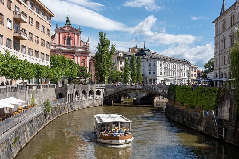 River Ljubljanica, sightseeing boat with passengers, triple bridge (Tromostovje), Ljubljana, Slovenia