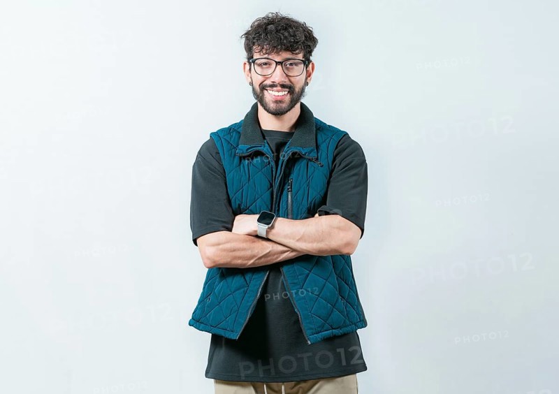 Portrait of cool and handsome casual man with glasses and crossed arms. Smiling and handsome guy with glasses holding arms crossed isolated