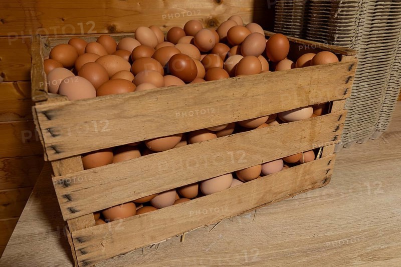 Natural fresh eggs in wooden boxes prepared by the farm for regional sale