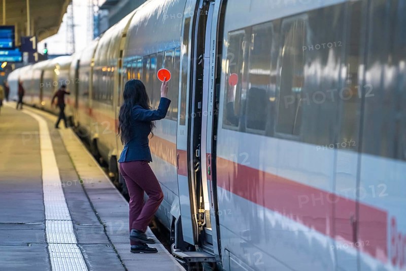 ICE train ready for departure, train staff waiting for the signal to continue, at Essen main station, on the platform, North Rhine-Westphalia, Germany
