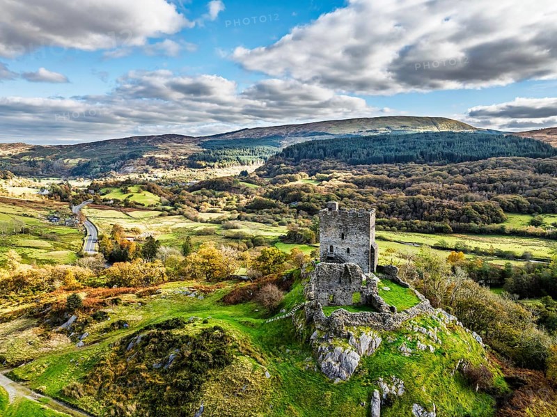 Autumn colours over Castell Dolwyddelan and Eryri Mountains from a drone, Snowdonia, Conwy County Borough, Wales, England, United Kingdom