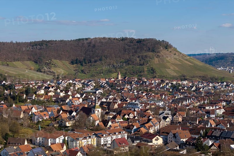 City view with hills in the background, lots of red house roofs and green surroundings under blue sky, Korb im Rems Valley, Baden-Württemberg, Germany