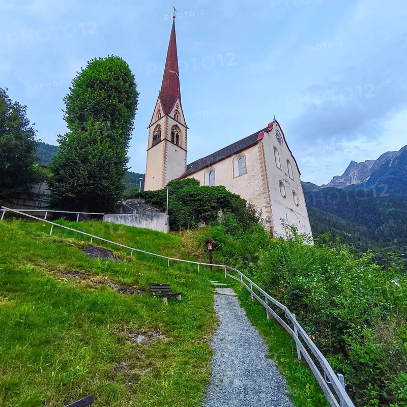 Late Gothic Catholic parish church of Saints George and Nicholas from around 1500 with churchyard, in Oetz im Ötztal, Tyrol, Austria