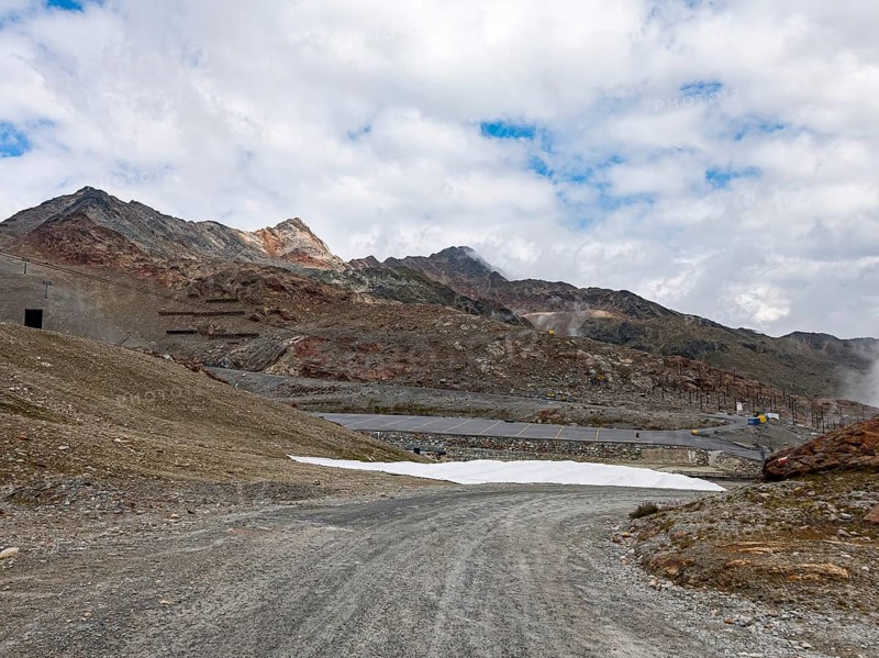 Alpine mountain landscape with covered snowfields at the valley station of the Tiefenbach cable car in the area of the Tiefenbach Glacier near Sölden, Ötztal, Tyrol, Austria