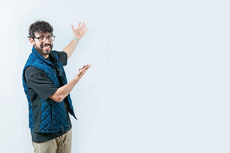 Handsome guy welcoming you on isolated bakground. Smiling Handsome Man Presenting something isolated