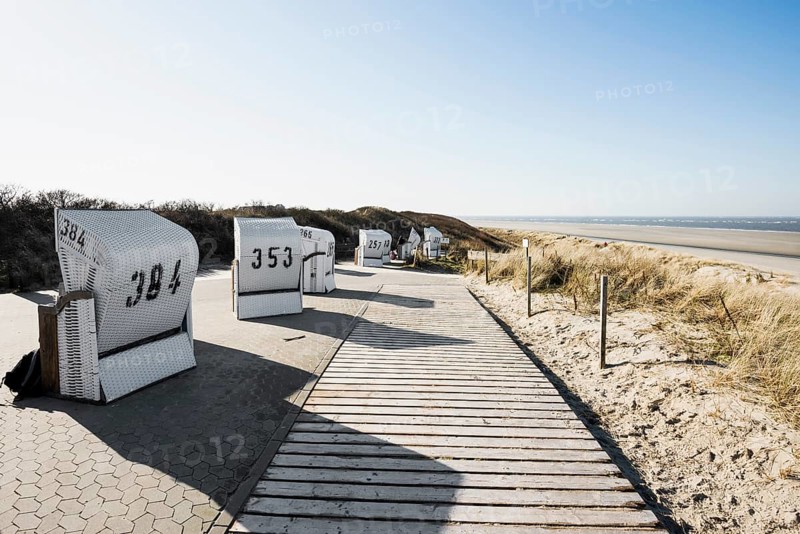 Beach chairs in the dunes and blue sky in winter, Spiekeroog, East Frisian Islands, Lower Saxony, Germany
