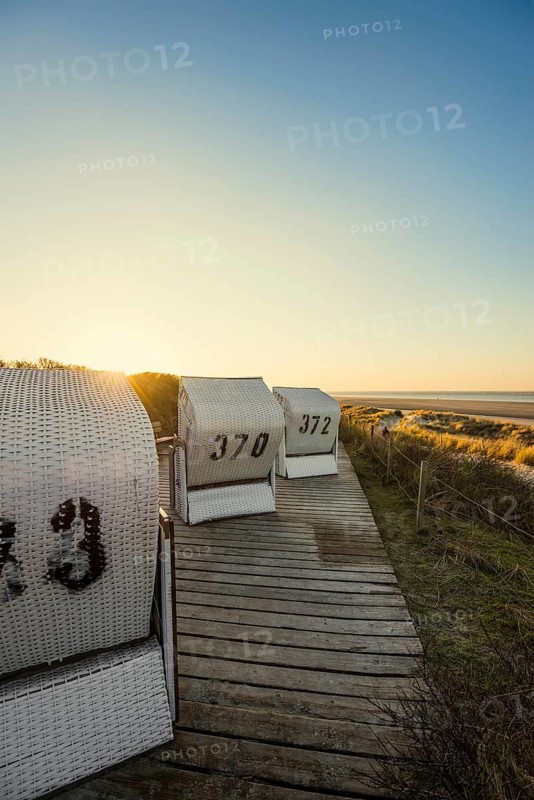 Beach chairs in the dunes and blue sky in winter, sunset, Spiekeroog, East Frisian Islands, Lower Saxony, Germany
