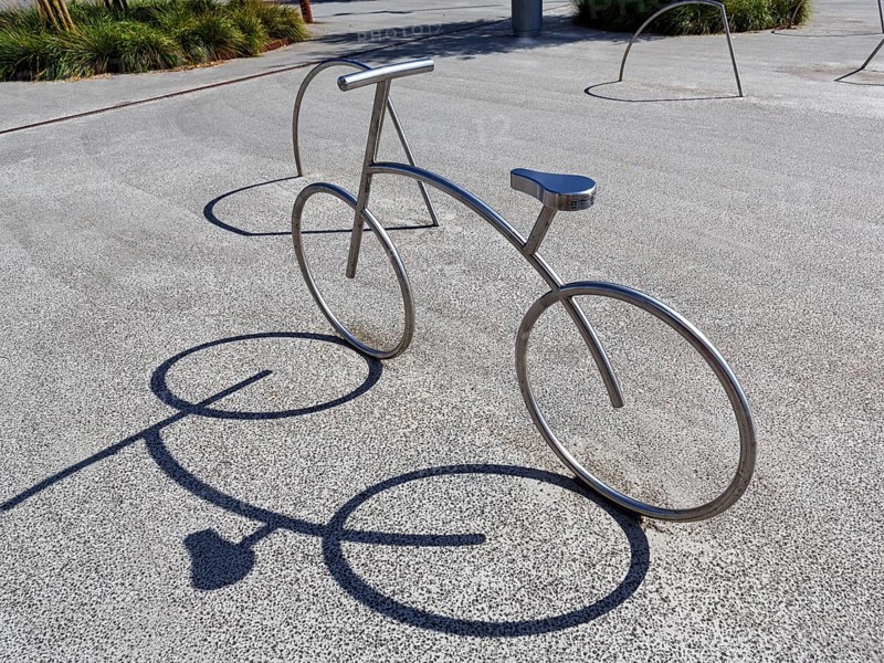 Bicycle, stainless steel bicycle rack, casts shade, bicycle parking, Aalborg, Jutland, Denmark