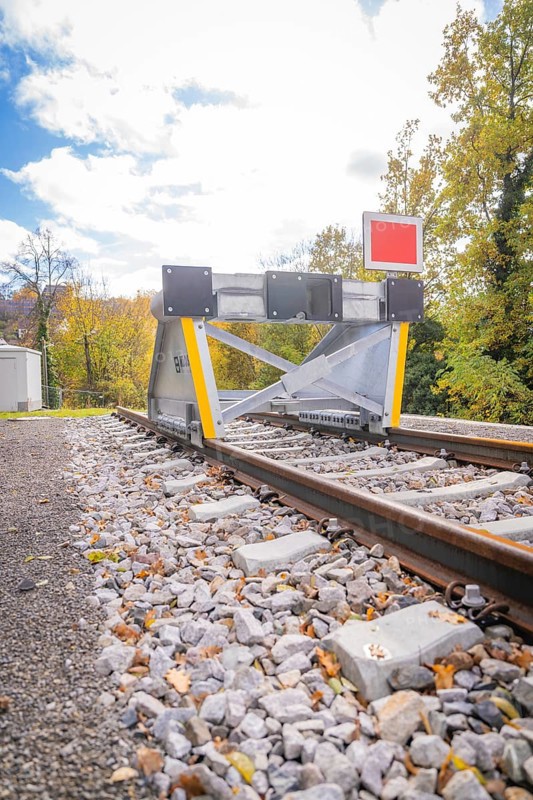 Rail end with barrier against autumn background and blue sky, ZOB Calw, Hermann Hessebahn, Calw, Germany