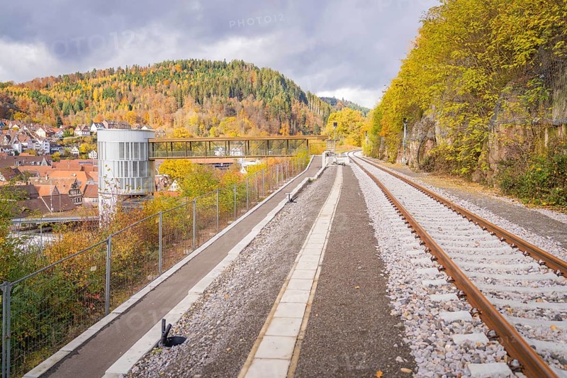Railway tracks in autumn landscape with views of wooded hills and a city, ZOB Calw, Hermann Hessebahn, Calw, Germany