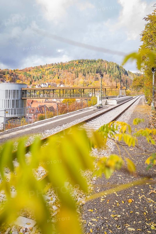Railway line along autumnal mountain landscape with modern architecture, ZOB Calw, Hermann Hessebahn, Calw, Germany