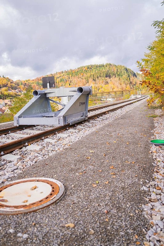End of train tracks with autumnal mountain landscape and cloudy sky, ZOB Calw, Hermann Hessebahn, Calw, Germany