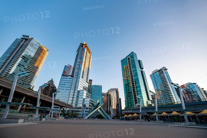 Olympic Cauldron Statue, Jack Poole Plaza Square, skyscrapers on the promenade at sunset, Coal Harbour, Vancouver, British Columbia, Canada