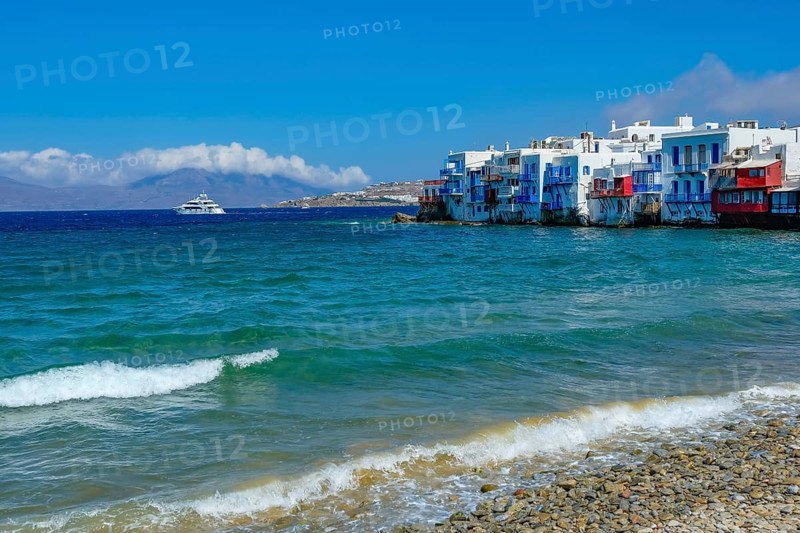 Mykonos, Cyclades, Greece - Little Venice is a picturesque neighborhood in Mykonos Town with colorful houses that stand right by the sea and are reminiscent of Venice. Little Venice is located on Alefkandra Bay next to the famous windmills of Mykonos. Mykonos is part of the Cyclades archipelago in the Aegean Sea