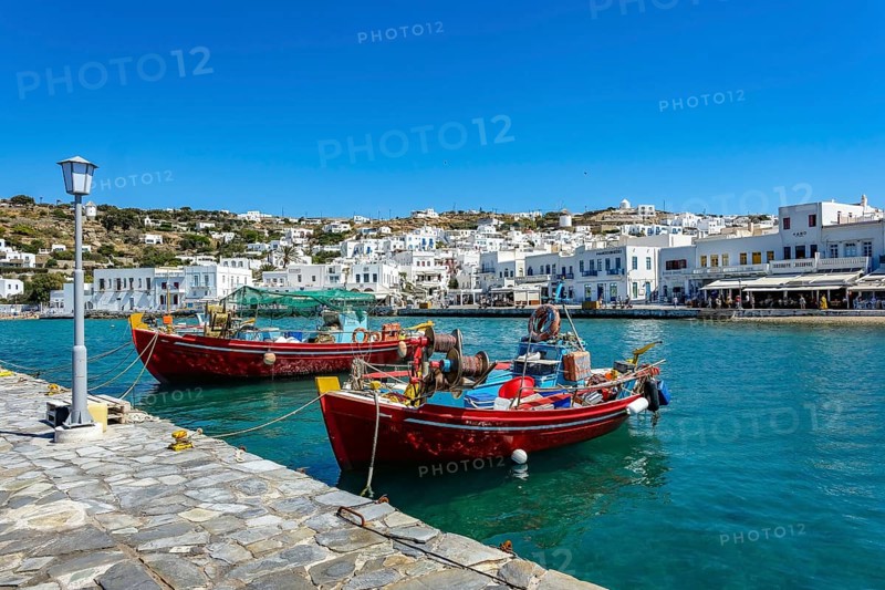 Mykonos, Cyclades, Greece - Colourful fishing boats are moored on the quay in the old port of Mykonos Town, Mykonos Chora. Mykonos is part of the Cyclades archipelago