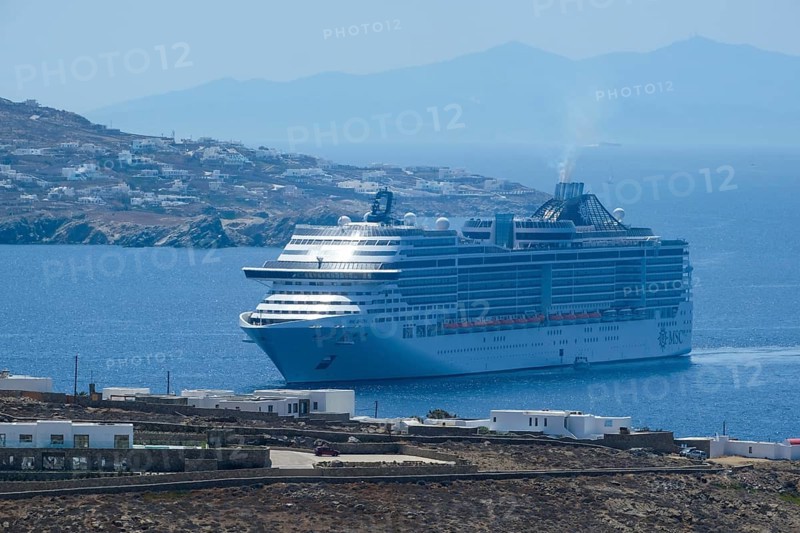 Mykonos, Cyclades, Greece - cruise ship MSC Divina sails to Mykonos harbour bay