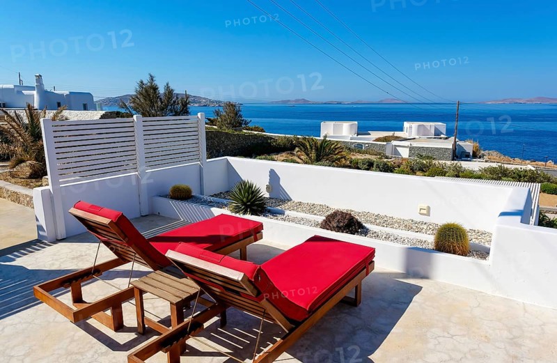 Mykonos, Cyclades, Greece - theme photo: vacation in Greece, sun loungers on the terrace of a boutique hotel with sea views