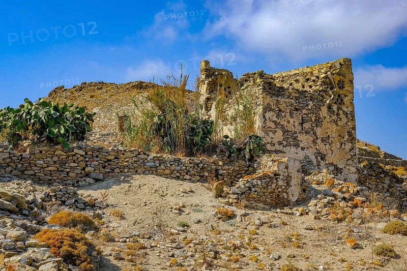 Ano Mera, Mykonos, Cyclades, Greece - Gyzi ruins, castle ruins from the 13th century by the Venetian Gyzi family, right next to the Paleokastro monastery in the interior of the island just outside Ano Mera, is now a tourist attraction much visited by tourists