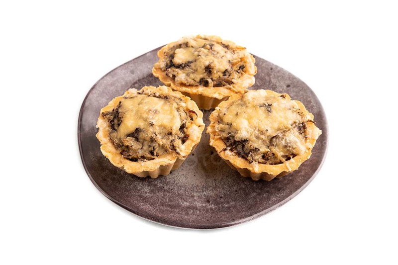 Tartlets with meat and cheese isolated on white background. side view, copy space