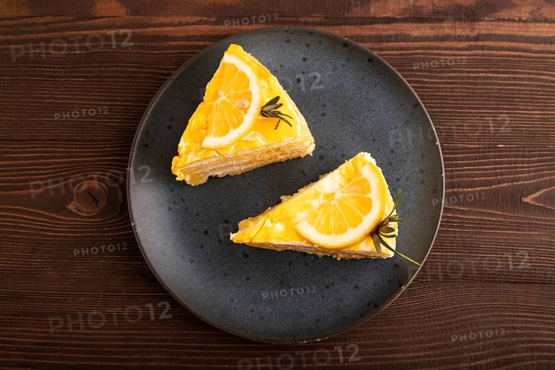 Lemon cake on brown wooden background, top view, flat lay, close up