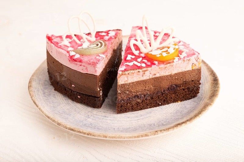 Chocolate cake on white wooden background, side view, close up