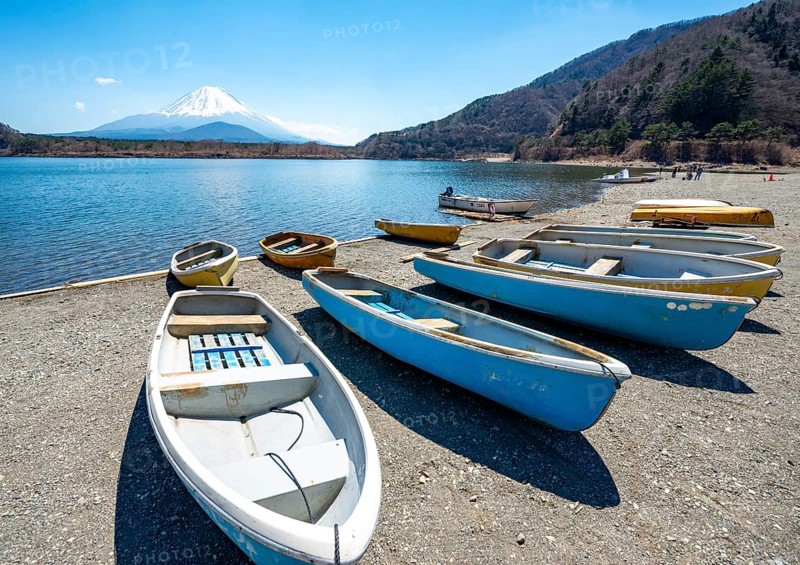 Rowing boats on shore, view across the lake to Mt Fuji volcano, Motosu Lake, Yamanashi Prefecture, Japan