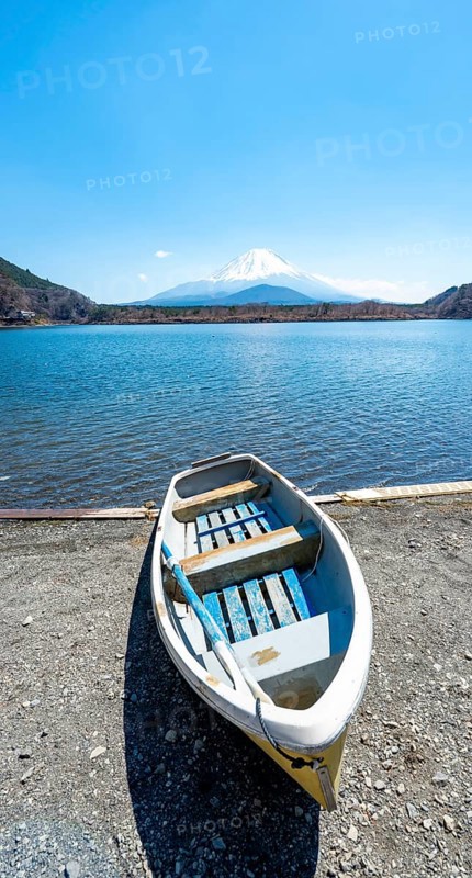 Rowing boat on shore, view across the lake to Mt Fuji volcano, Motosu Lake, Yamanashi Prefecture, Japan