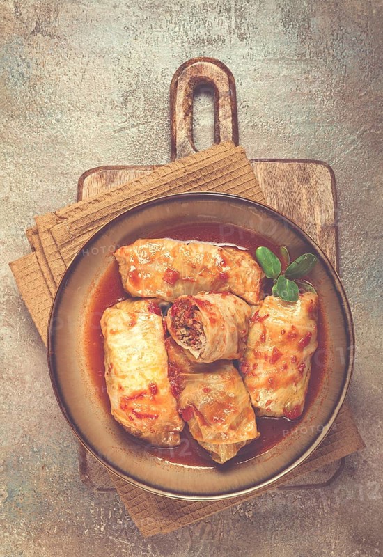 Stuffed cabbage rolls with minced meat, in tomato sauce, top view, without people, in the spotlight