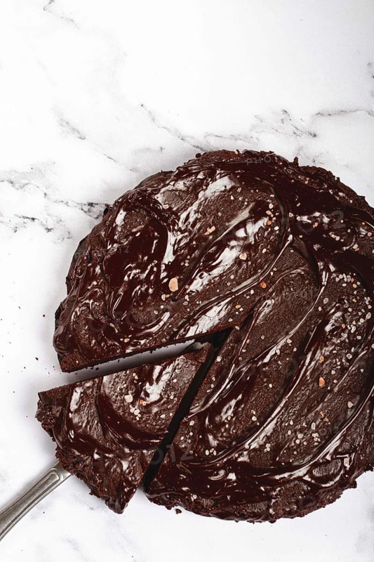 Chocolate cake, round cake, on a marble light table, top view, homemade cakes, no people