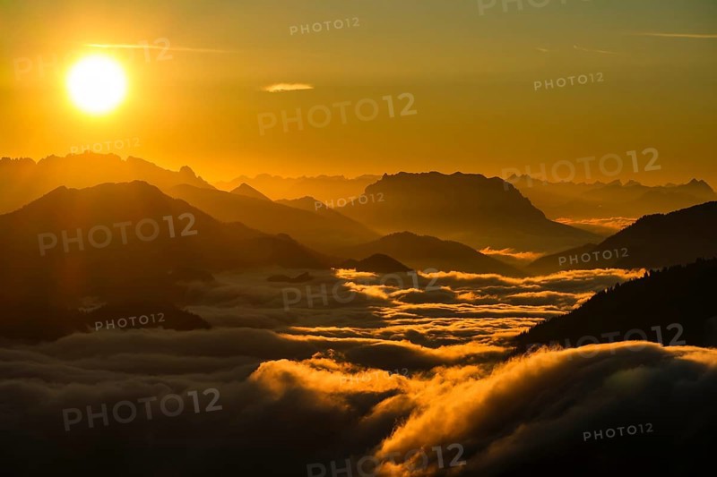Silhouette of mountains at sunset, fog in valley, Wilder Kaiser and Chiemgau Alps, Upper Bavaria, Bavaria, Germany