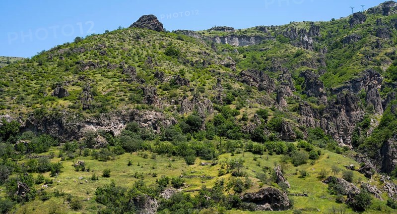 Green hills and rocky landscape under a clear summer sky, landscape near Goris, Hoodoos, Syunik province, Syunik, Armenia