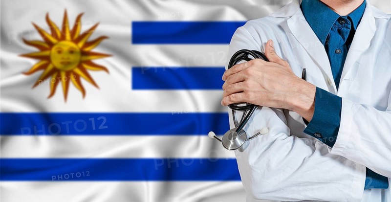 Uruguay healthcare concept. Doctor with stethoscope on Uruguay flag. Doctor holding stethoscope on Uruguayan flag