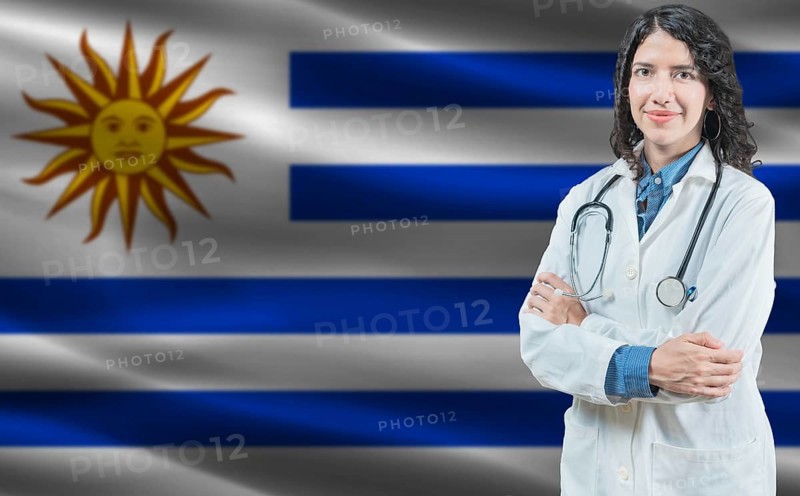 Uruguayan medicine and healthcare concept. Doctor close up against Uruguay flag background