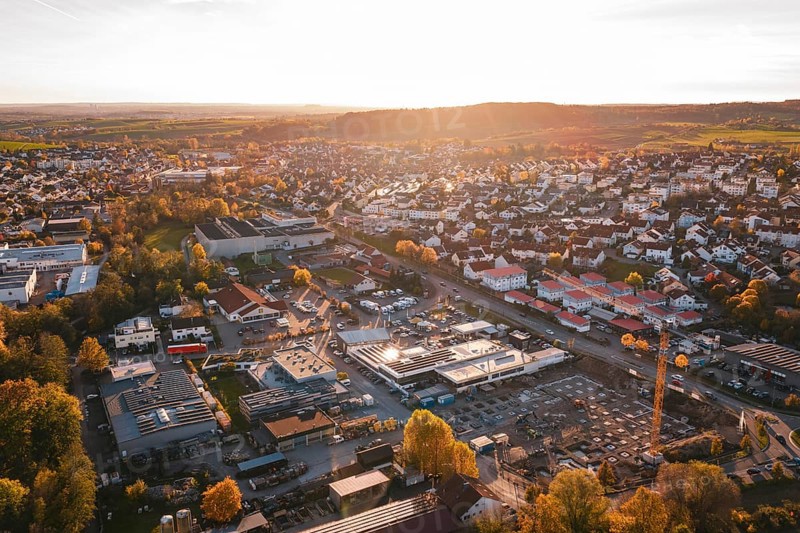 Small town with industrial facilities in warm evening autumn light, Grossbottwar, Germany