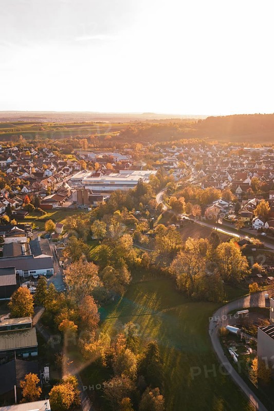 View of small town with lots of trees and autumn light at sunset, Grossbottwar, Germany