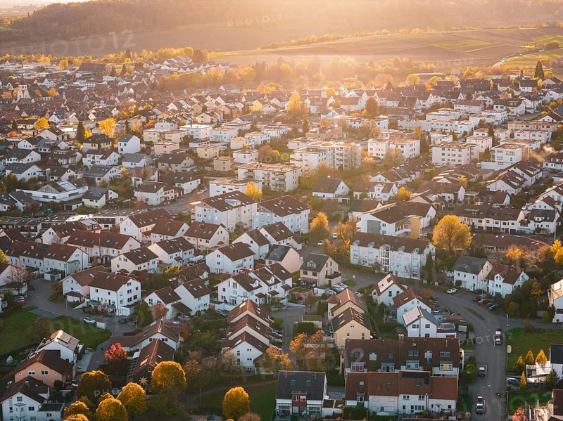 Dense residential area with autumn colors and festive sunset light, Großbottwar, Germany