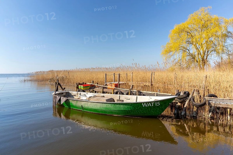 Fishing boat moored at wooden jetty at the Lieper Winkel peninsula near Rankwitz on Usedom island in the Baltic Sea, Mecklenburg-Vorpommern, Germany