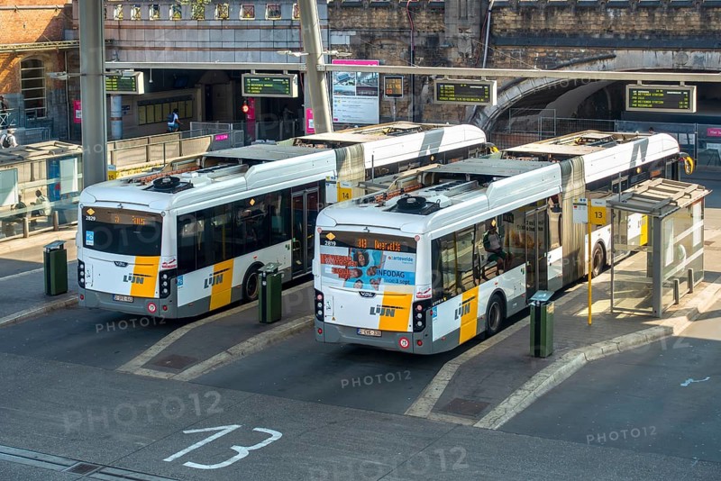 Two commuter buses at bus stop of public transport company De Lijn at train station Gent-Sint-Pieters in the city Ghent, East Flanders, Belgium