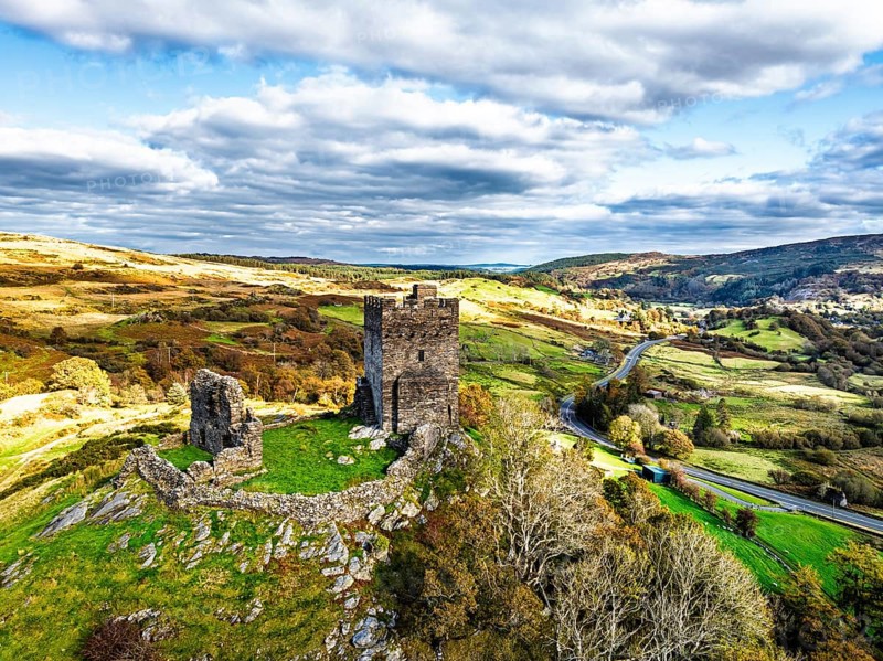 Autumn colours over Castell Dolwyddelan and Eryri Mountains from a drone, Snowdonia, Conwy County Borough, Wales, England, United Kingdom