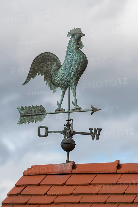 Rooster on metal weather vane on a tiled roof, clouds in the background, Baden-Württemberg, Germany