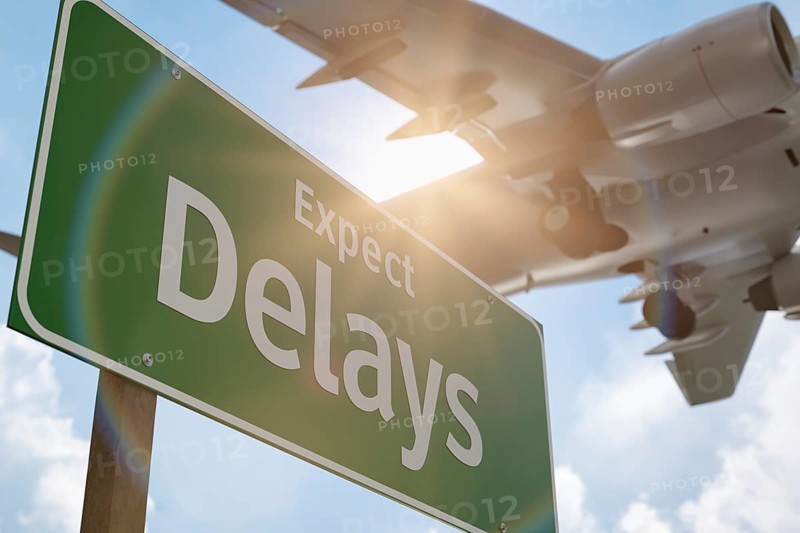 Expect delays green road sign with airplane above