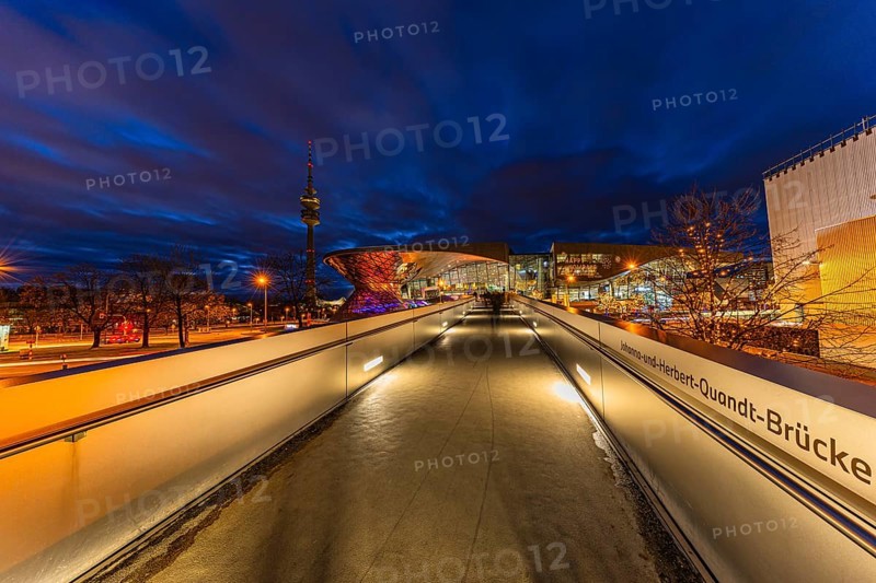 Evening atmosphere at BMW World, Johanna and Herbert Quandt bridge, in the back the TV tower in the Olympic Park, Petuelring, Munich, Upper Bavaria, Bavaria, Germany