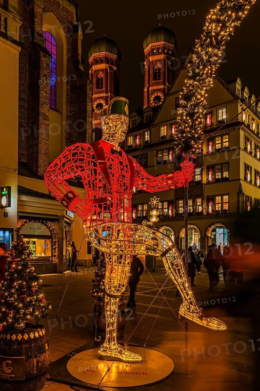 Schäffler dancers made of wire and string of lights, in the back the towers of the Church of Our Lady, Cathedral of Our Lady, Christkindlmarkt, Neuhauserstraße, Munich, Upper Bavaria, Germany