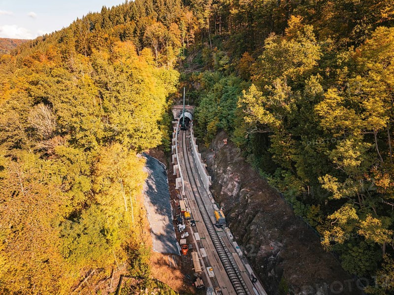 Layered view of an autumn rail construction site in the forest with construction vehicles, construction of Hermann, Hesse, Bahn, Calw, Germany