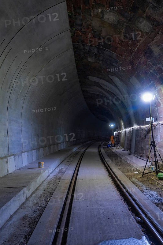 Tunnel with rails and bright lighting along the wall, dark building atmosphere, Hermann building, Hesse, railway, Calw, Germany