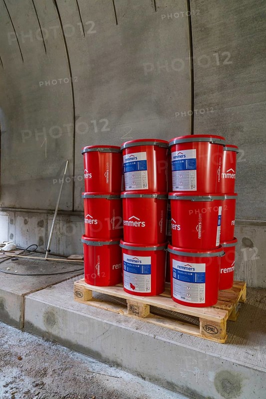 Red paint buckets on a pallet in a tunnel setting, building materials stored, building of Hermann, Hesse, Bahn, Calw, Germany