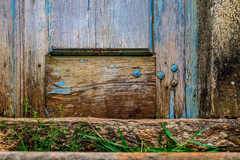 Details of an old baroque church door made of wood, weathered by time, in Ouro Preto city, Ouro Preto, Minas Gerais, Brazil