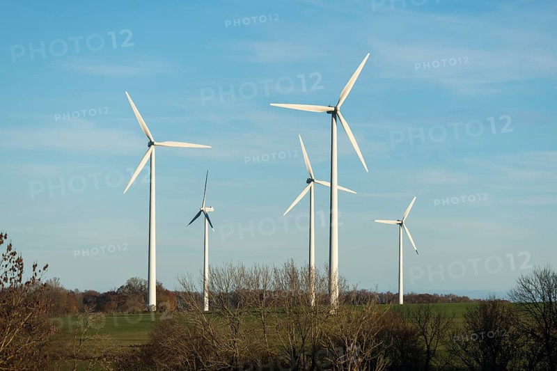 Wind turbines stand on a wide meadow under a clear blue sky, Swabian Jura, Baden-Württemberg, Germany
